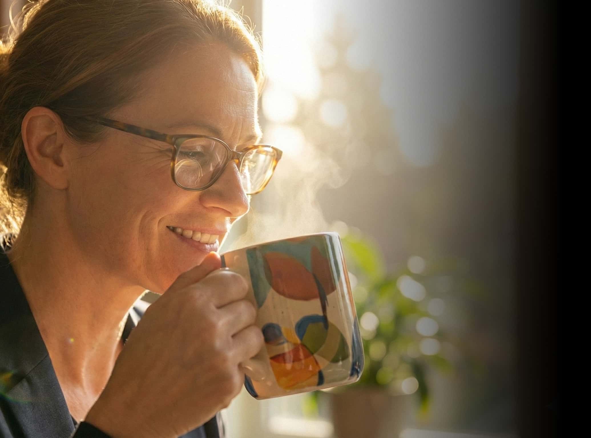 Attorney smiling while holding a hand crafted coffee mug